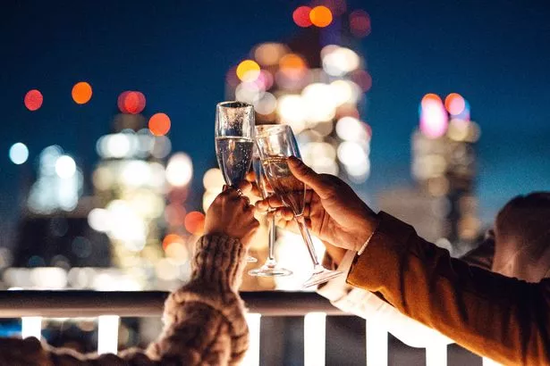  businesspeople having Friday night drinks at rooftop in office building