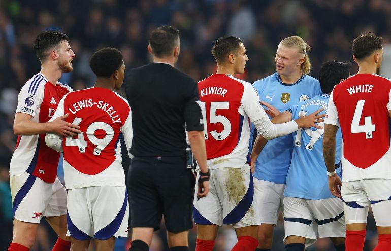Arsenal's Myles Lewis-Skelly clashes with Manchester City's Erling Haaland