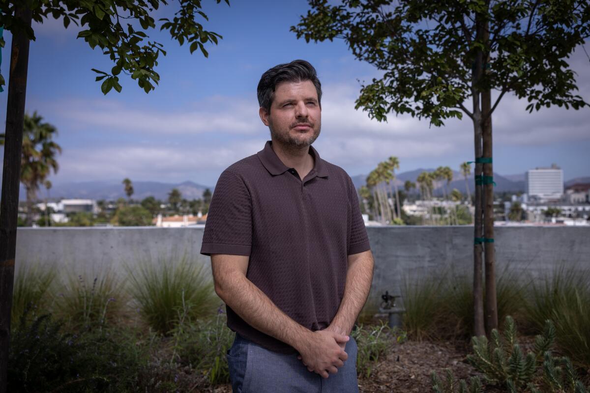 Matthew Tinker, president of David E. Kelley Productions, stands on a rooftop.