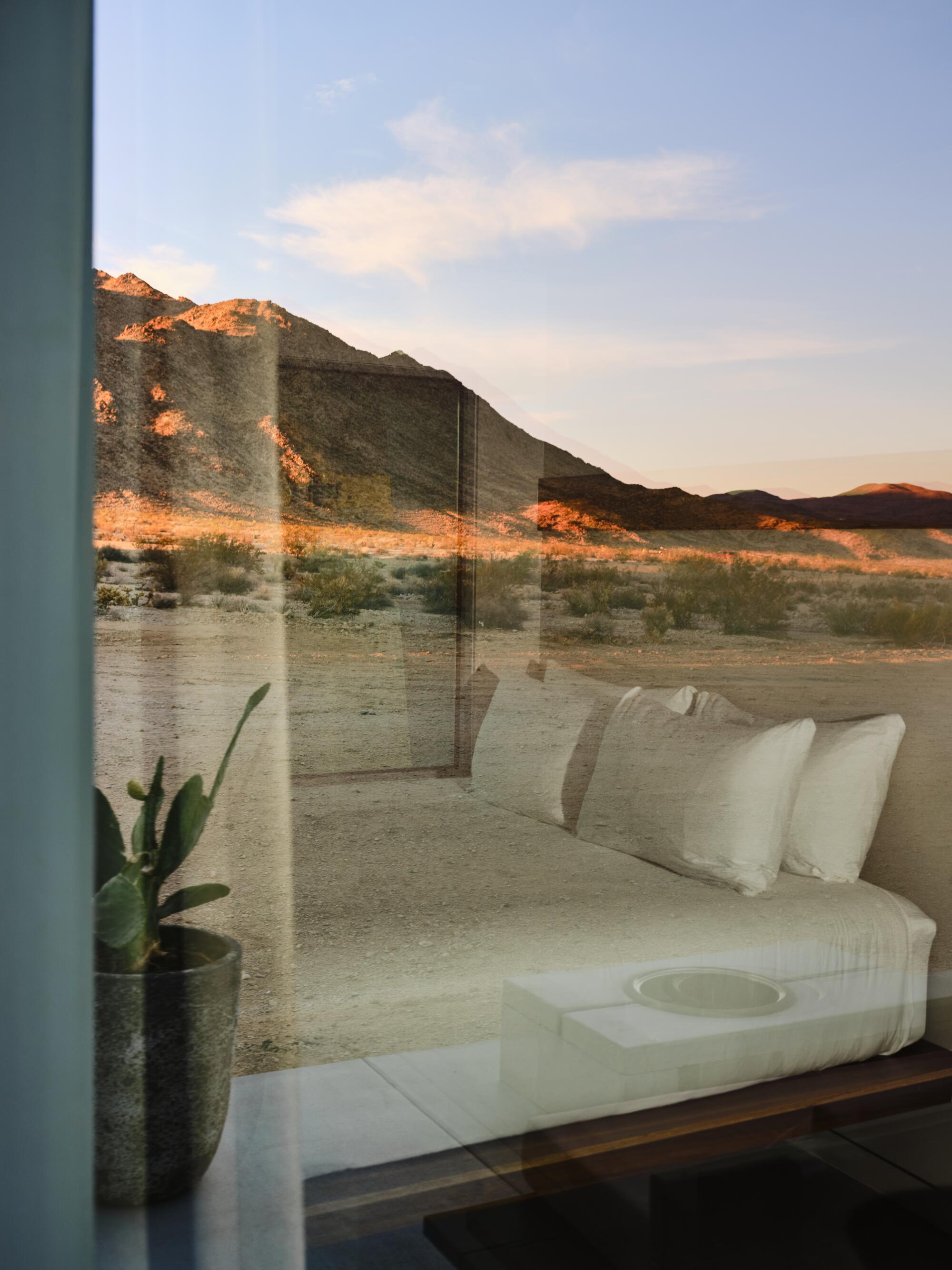 A mountain glowing orange at sunset is visible from one of Reset Hotel's 65 modular rooms.