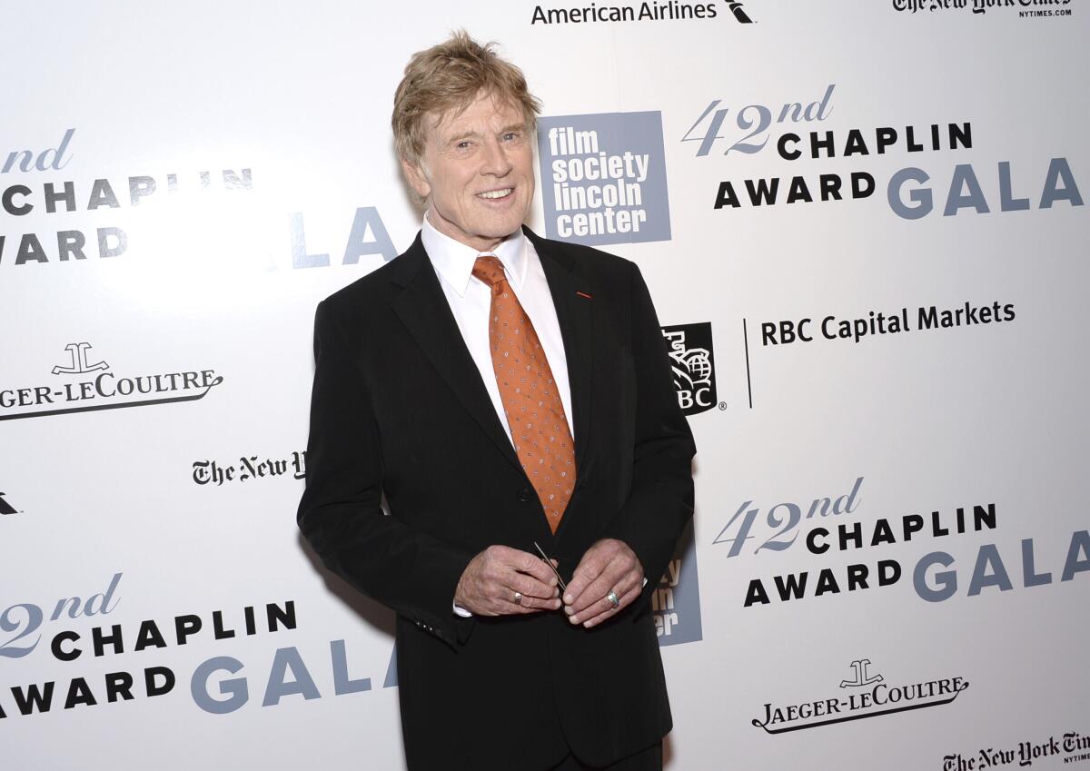 A man in a suit smiles at a gala.