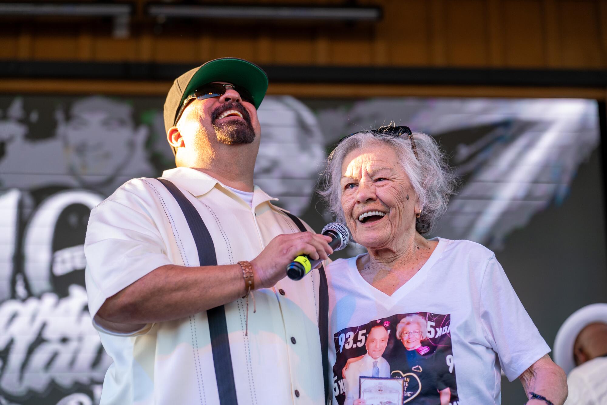 DJ Angel Rodriguez, who carries on a tribute to Art Laboe, and a longtime fan, Proxie Aguirre, 82.