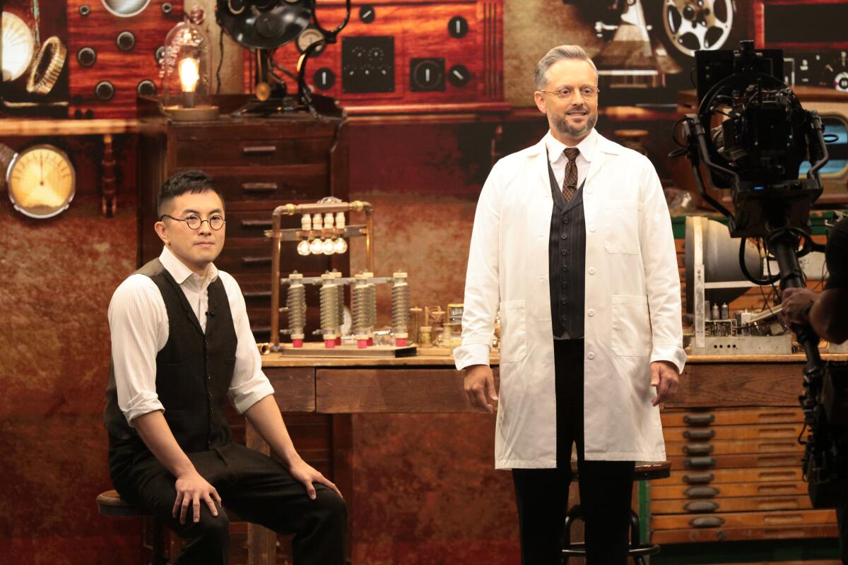 Two men in an electronics lab on a TV set.