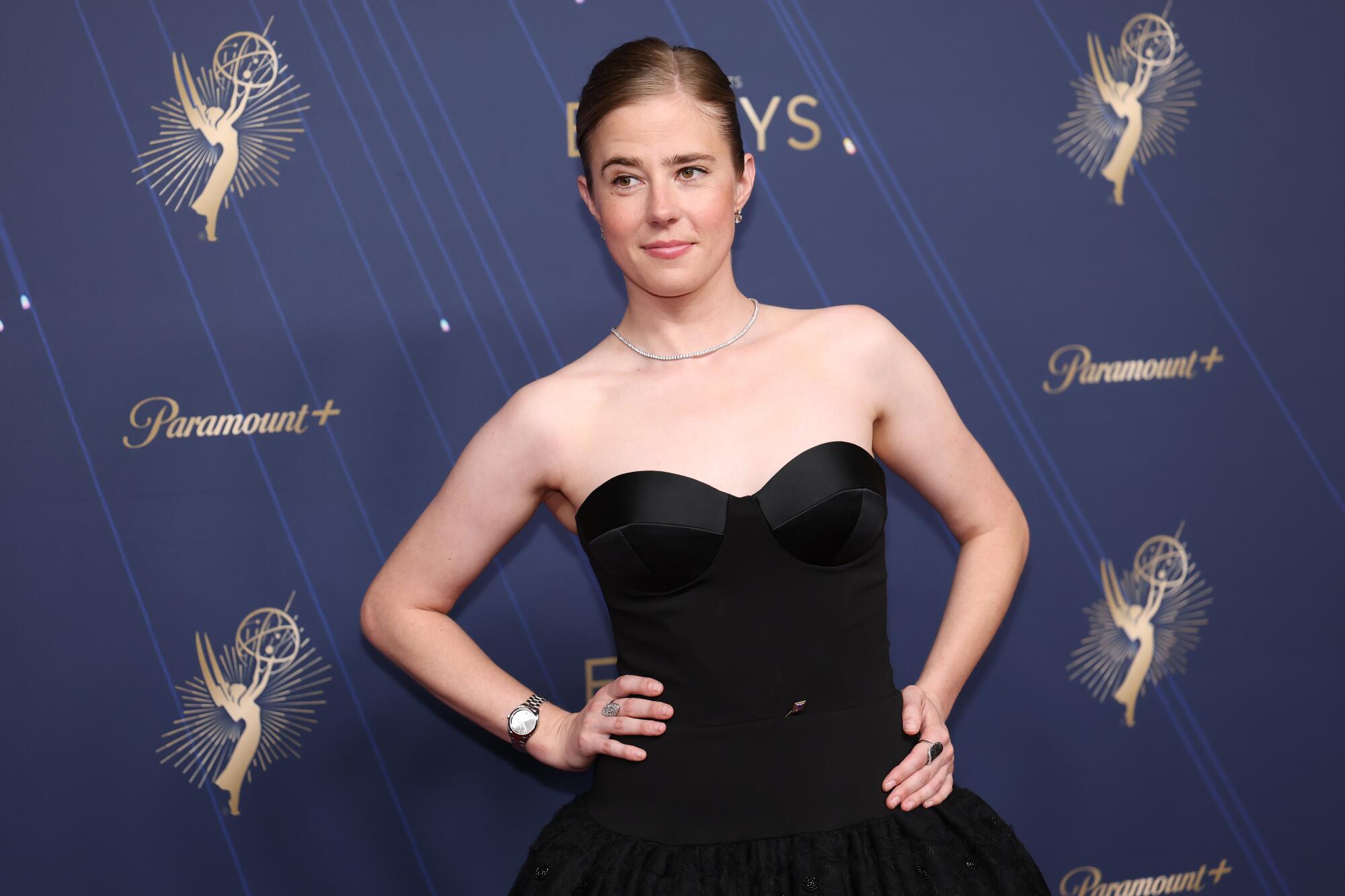 Taylor Dearden wears a strapless black dress with a sweetheart neckline.