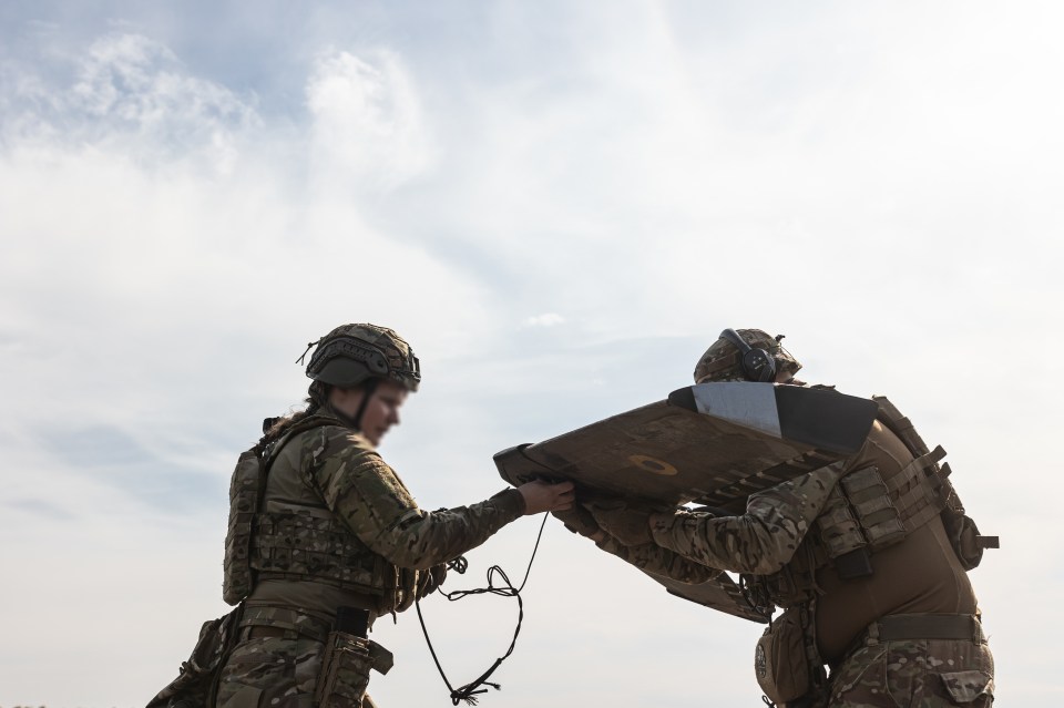 Ukrainian soldiers launching a reconnaissance drone.