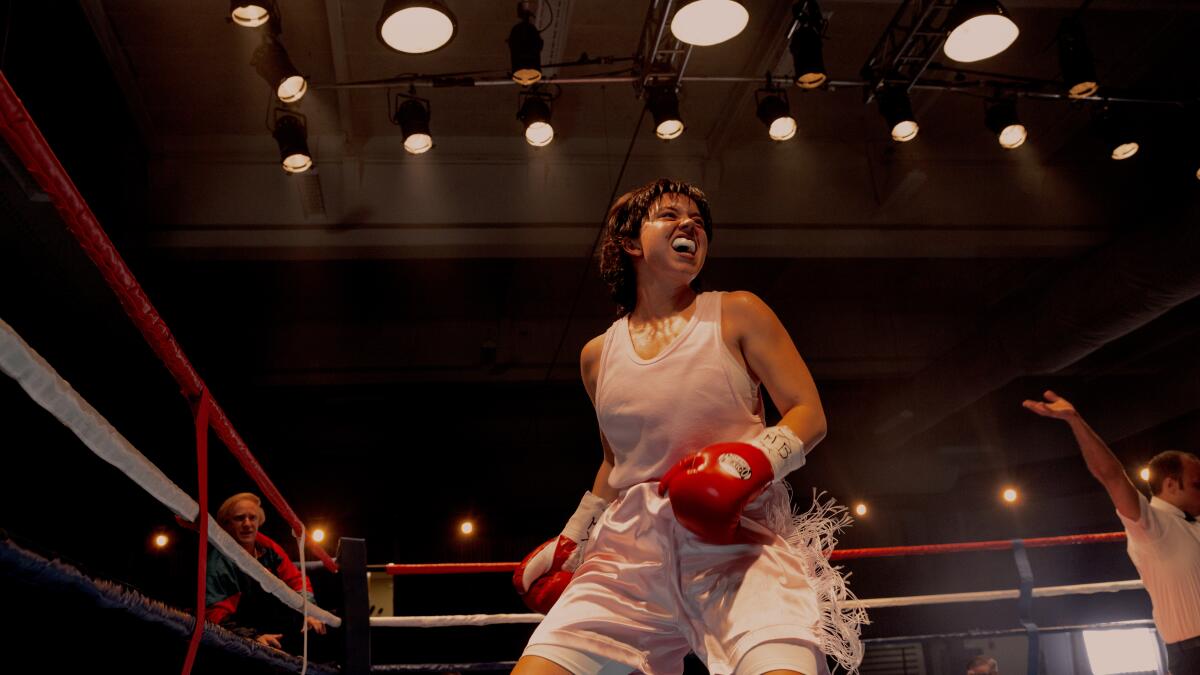 A woman boxer triumphs in the ring.
