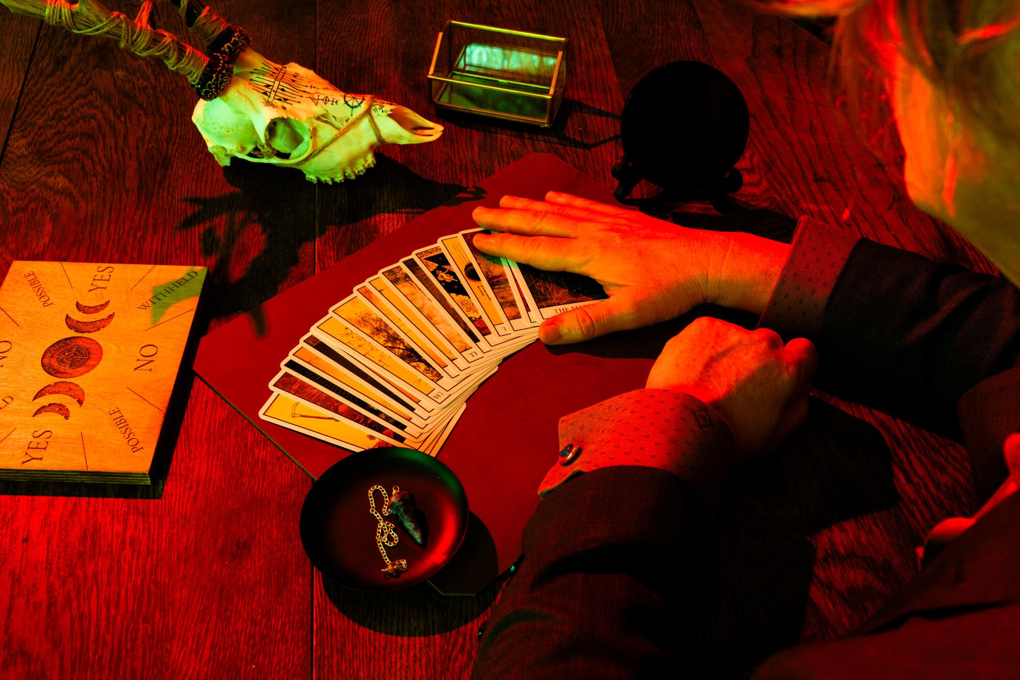 A tarot deck and a spirit board on a table. 