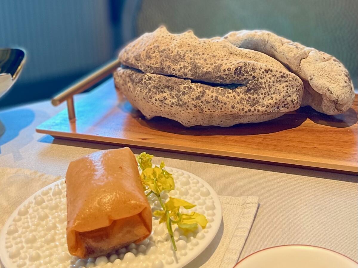 The sea cucumber spring roll, front, at Wing in Hong Kong with a display of dried sea cucumber.