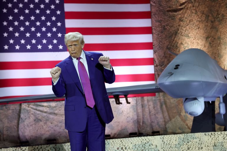 DOHA, QATAR - MAY 15: U.S. President Donald J. Trump gestures on stage as he tours the Al Udeid Air Base on May 15, 2025, in Doha, Qatar. Trump is on the third day of his visit to the Gulf to underscore the strategic partnership between the United States and Qatar, focusing on regional security and economic collaboration. (Photo by Win McNamee/Getty Images)
