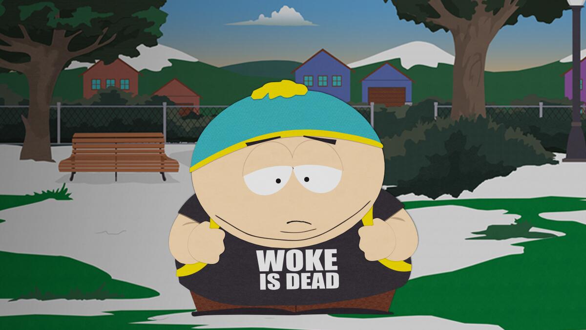 An animated still of a boy wearing a blue beanie and black T-shirt with the words "Woke is dead."