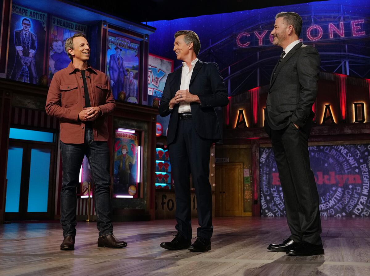 Three men standing on a stage.