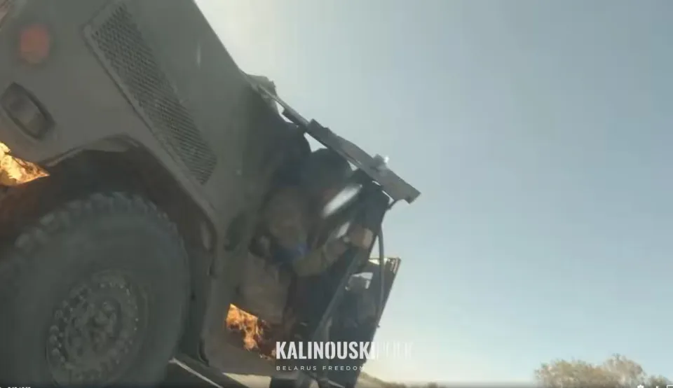 A military vehicle, possibly a Humvee, on fire with "KALINOUSKIEU BELARUS FREEDOM" text overlay.