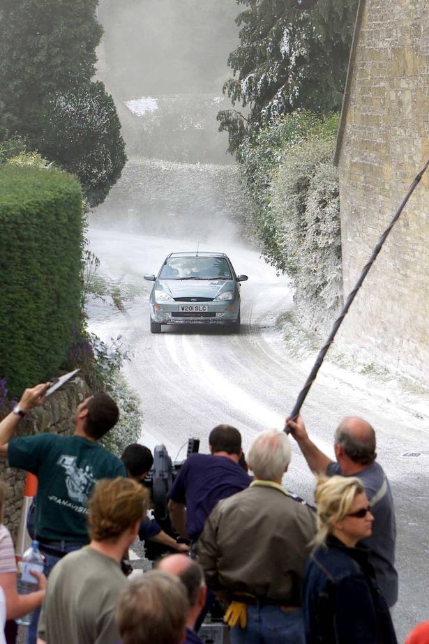 FILE PHOTO - Fiming for Bridget Jones's Diary in the Cotswold village of Snowshill. // Locals in a Cotswold village which featured in the film 'Bridget Jones's Diary' have slammed strict new planning rules - which mean they'd even need permission for a patio. Snowshill appeared in the 2001 movie where its green and a local house featured as the home of the title character's parents. But as of this week the 'jewel of the Cotswolds' will come under an Article 4 Direction by Tewkesbury Borough Council - strict laws rules to protect its heritage. It means virtually any work or alterations to buildings must be cleared by the authority - such as putting in patios or changing the colour of an exterior wall.