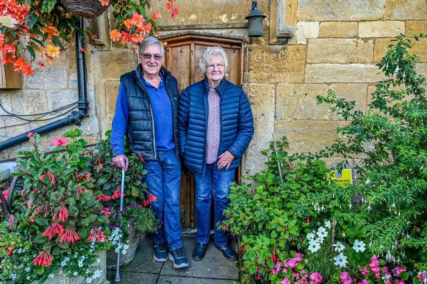 Peter and Sheila Wilkes in the Cotswold village of Snowshill. // Locals in a Cotswold village which featured in the film 'Bridget Jones's Diary' have slammed strict new planning rules - which mean they'd even need permission for a patio. Snowshill appeared in the 2001 movie where its green and a local house featured as the home of the title character's parents. But as of this week the 'jewel of the Cotswolds' will come under an Article 4 Direction by Tewkesbury Borough Council - strict laws rules to protect its heritage. It means virtually any work or alterations to buildings must be cleared by the authority - such as putting in patios or changing the colour of an exterior wall.