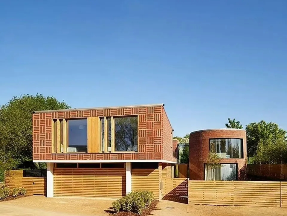 Cheryl Tweedy's former home in Hertfordshire, a modern house with brick patterns and wooden accents.