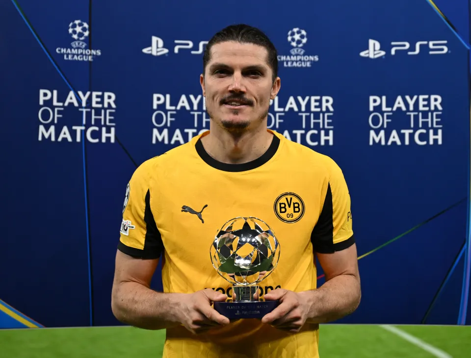 Marcel Sabitzer of Borussia Dortmund holding the PlayStation Player Of The Match award.