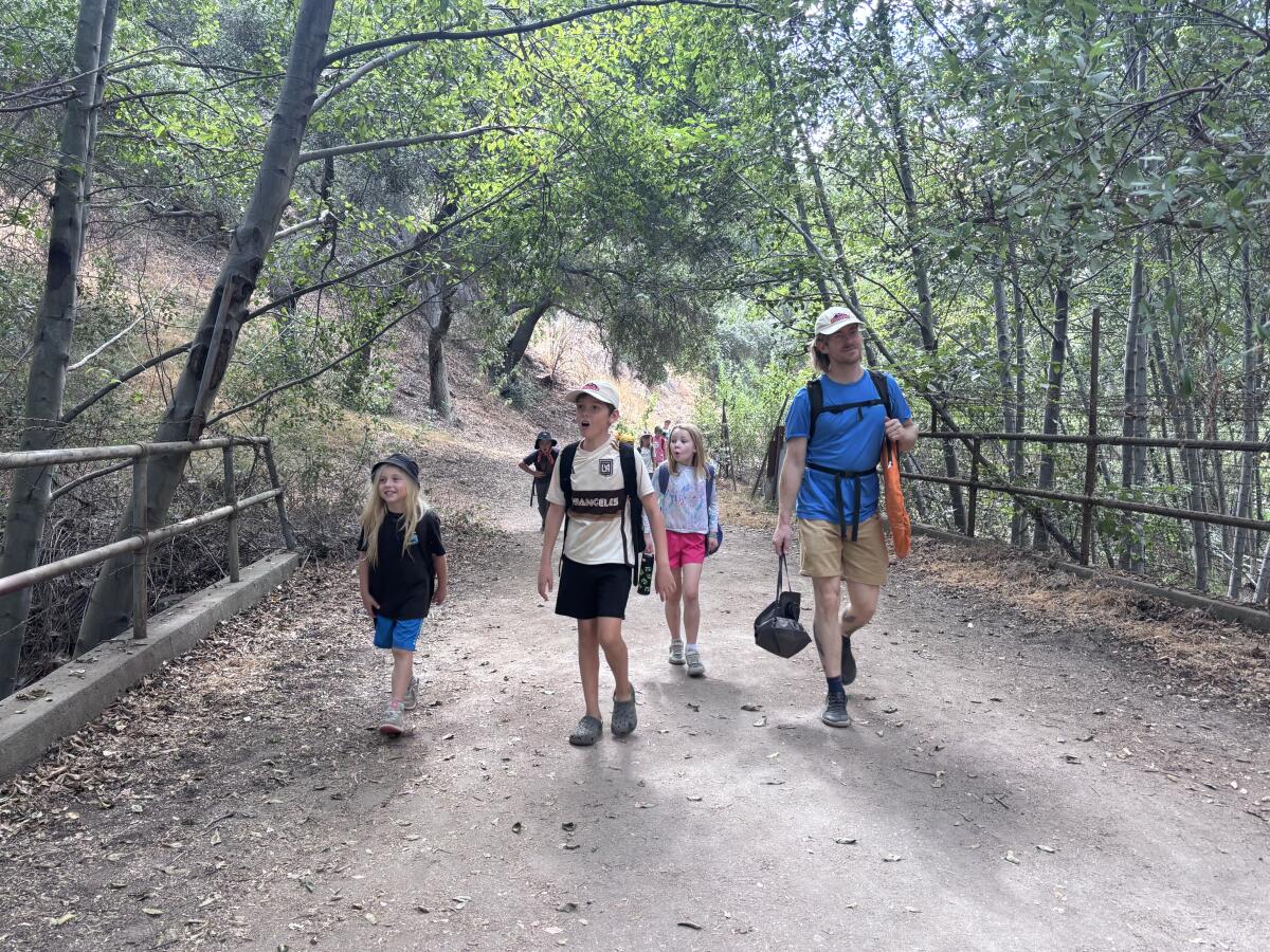 HAWKs hike leader Bradley Rydholm leads children down the Gabrielino Trail near Pasadena.