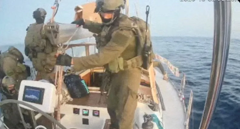 Military personnel on a boat at sea.