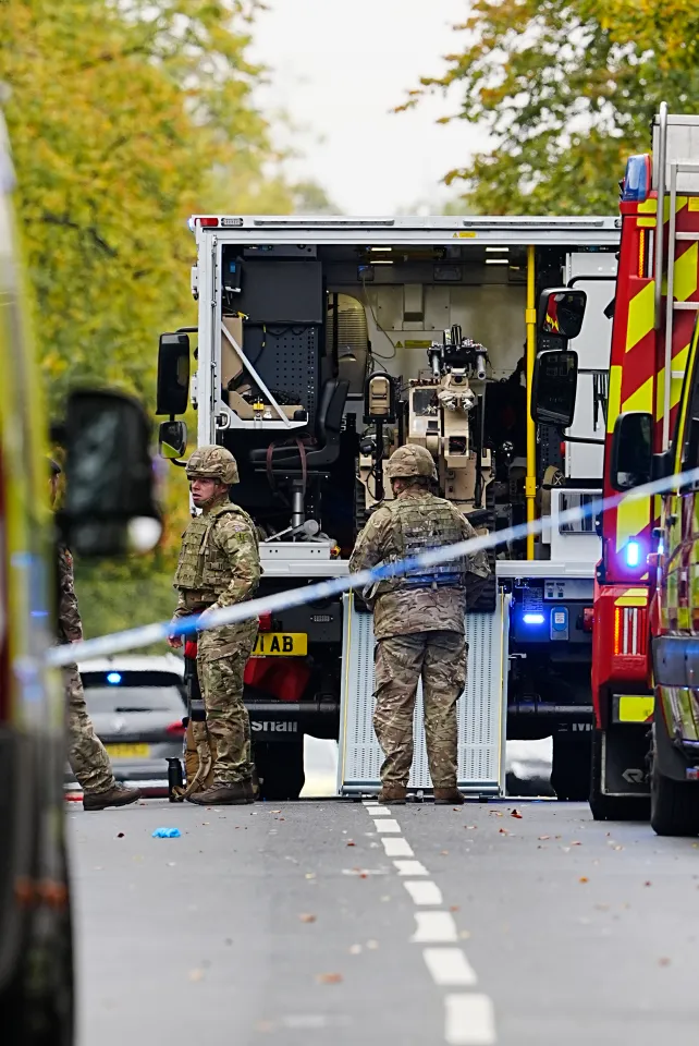 Members of the army unload a bomb disposal robot.