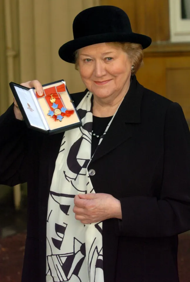 Patricia Routledge, CBE, holding her award at Buckingham Palace.