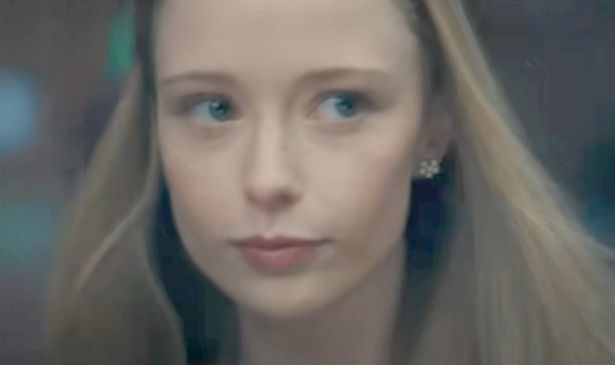 A blonde girl looks serious 