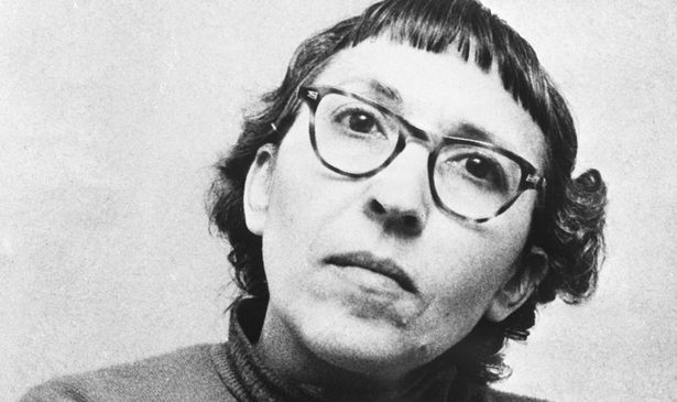 A black-and-white photo of a woman in glasses