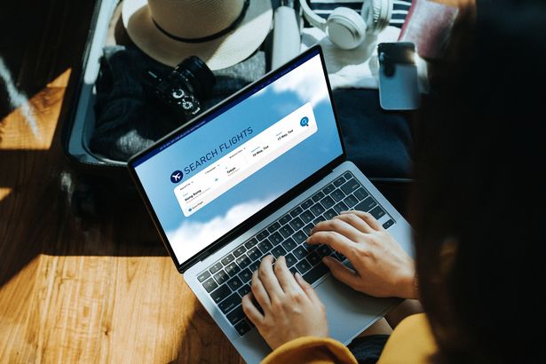 Young Asian woman shopping online for flight ticket on airline website 