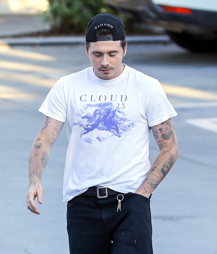 Brooklyn Beckham wearing a "Cloud 23" t-shirt and baseball cap.