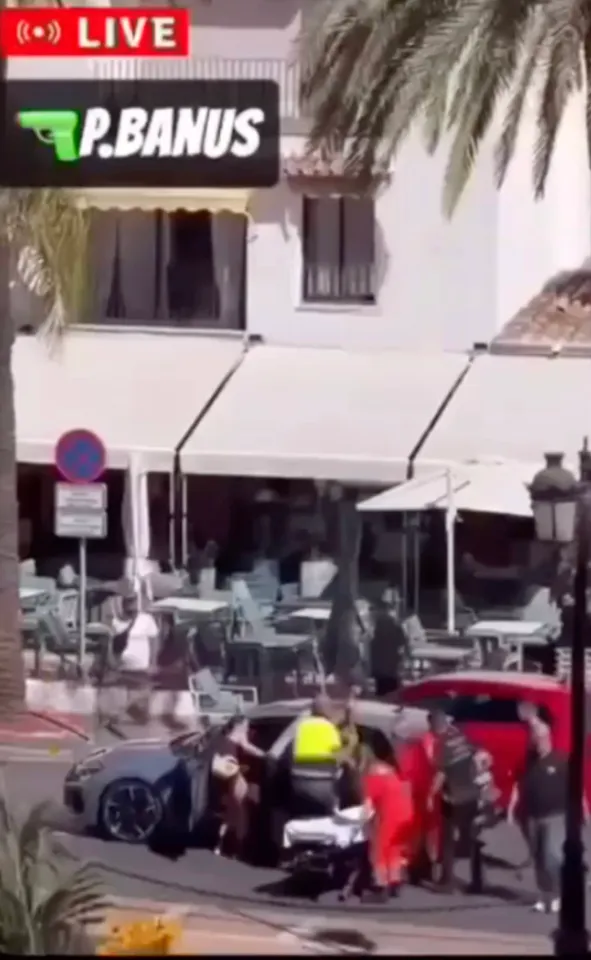 Emergency personnel attend to a shooting victim in Puerto Banus.