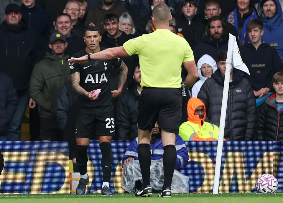 Pedro Porro of Tottenham Hotspur reacts after being struck by a vape from the stands.