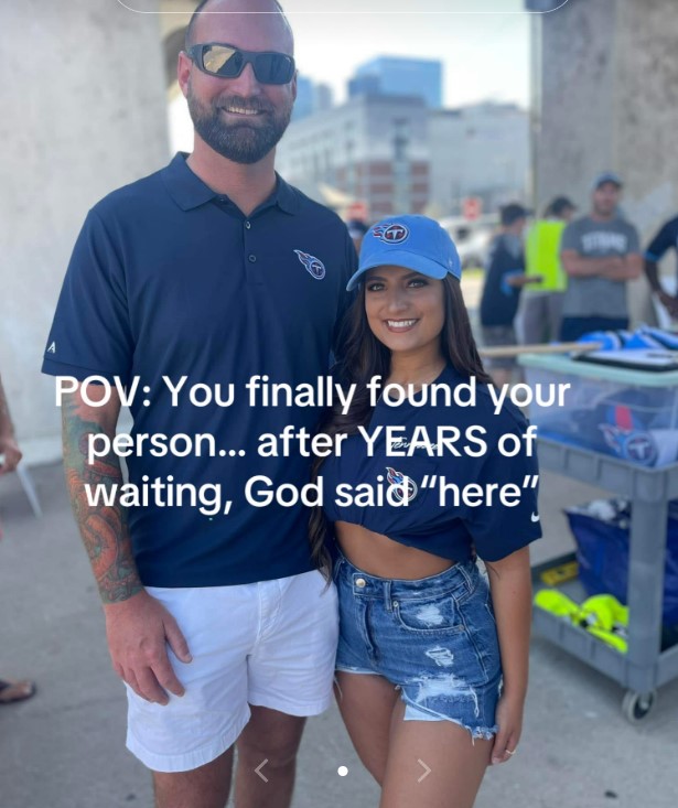 A man wearing sunglasses and a woman wearing a blue baseball cap smiling at the camera.