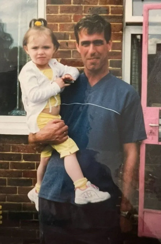 Peter Colville holding his daughter Nakita as a little girl.