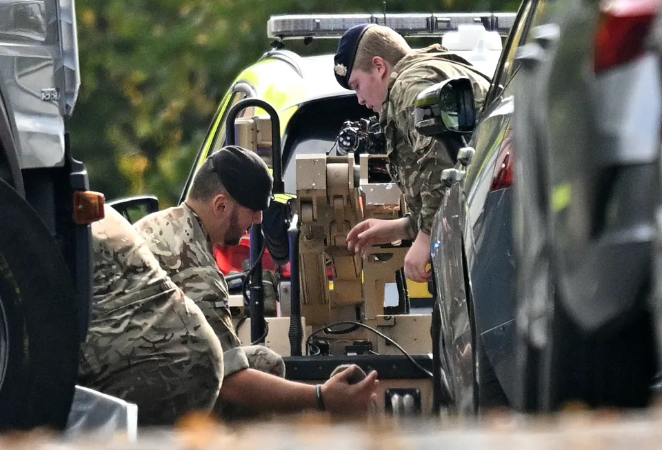 Military personnel prepare a bomb disposal robot inside a police cordon at Heaton Park Hebrew Congregation synagogue.