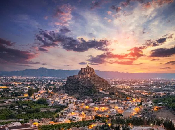 Dreamy sunset over Murcia with Monteguado castle on background.