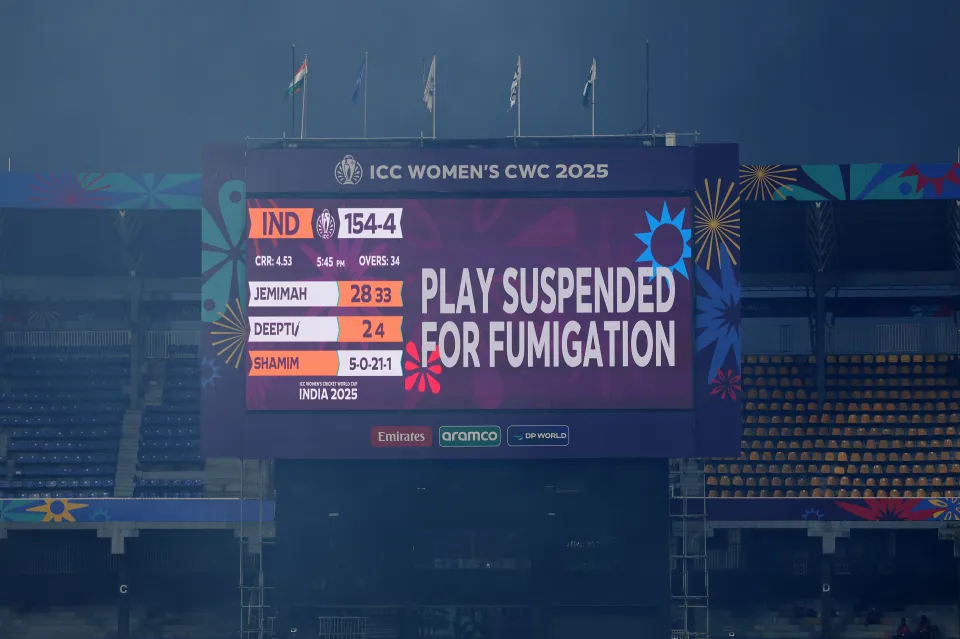 A stadium screen displaying "PLAY SUSPENDED FOR FUMIGATION" for the ICC Women's Cricket World Cup between India and Pakistan.