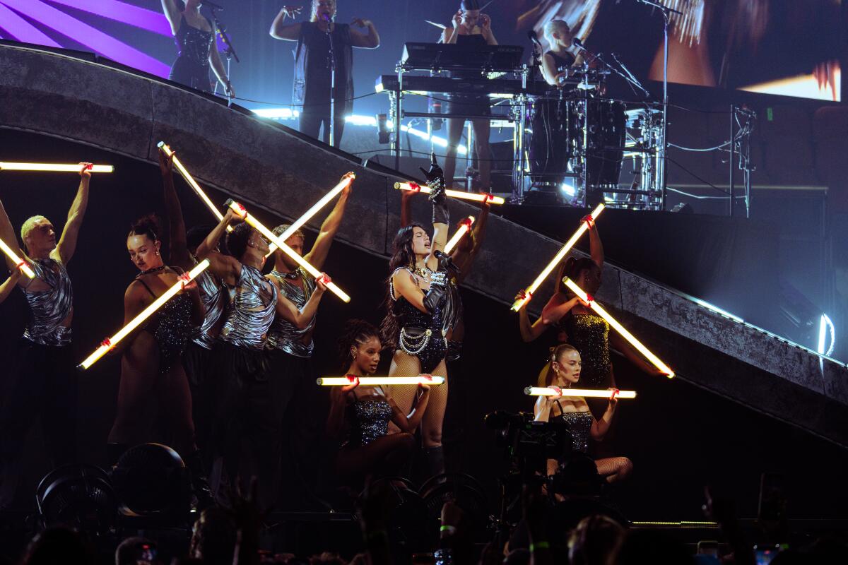 Dua Lipa sings and dances onstage