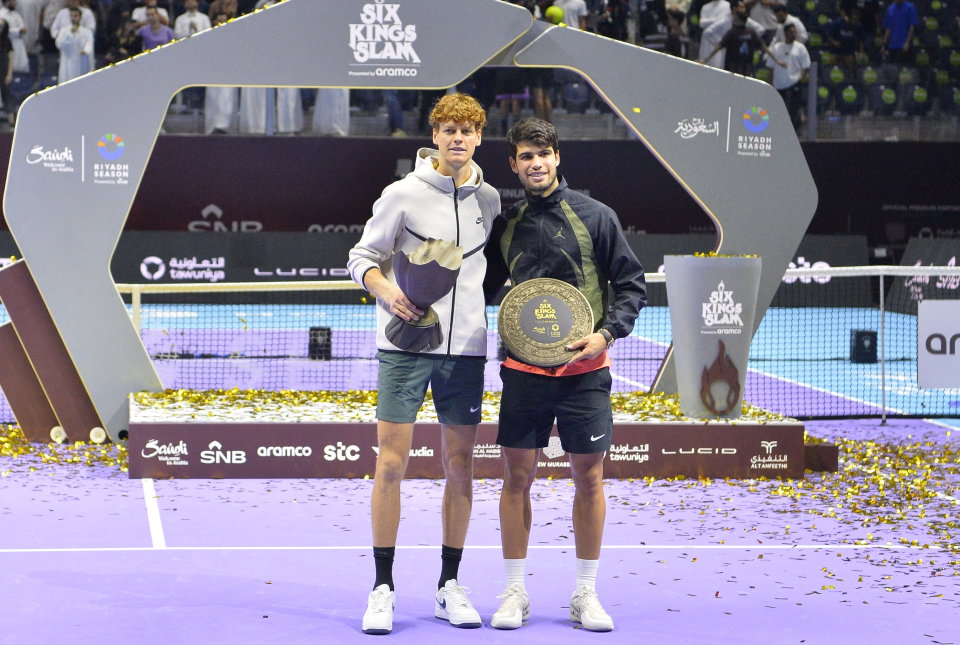 Jannik Sinner and Carlos Alcaraz posing with their trophies after the 2024 Six Kings Slam Tournament.