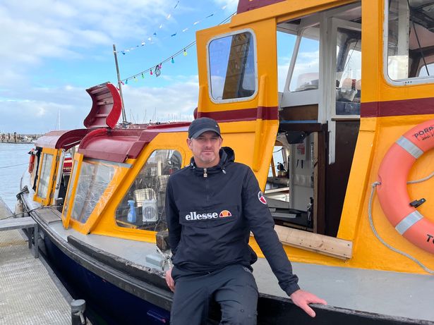 Ross by his boat