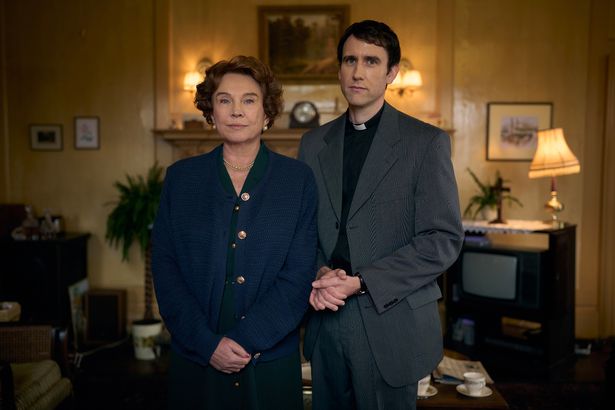 A man and woman looking serious into the camera