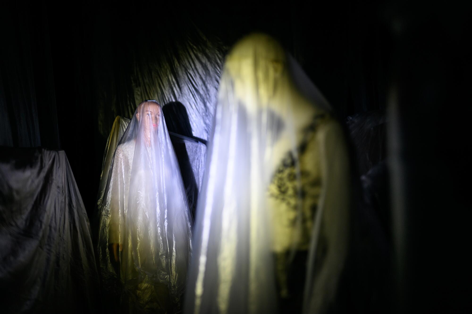 Ghostly figures in a dark room.