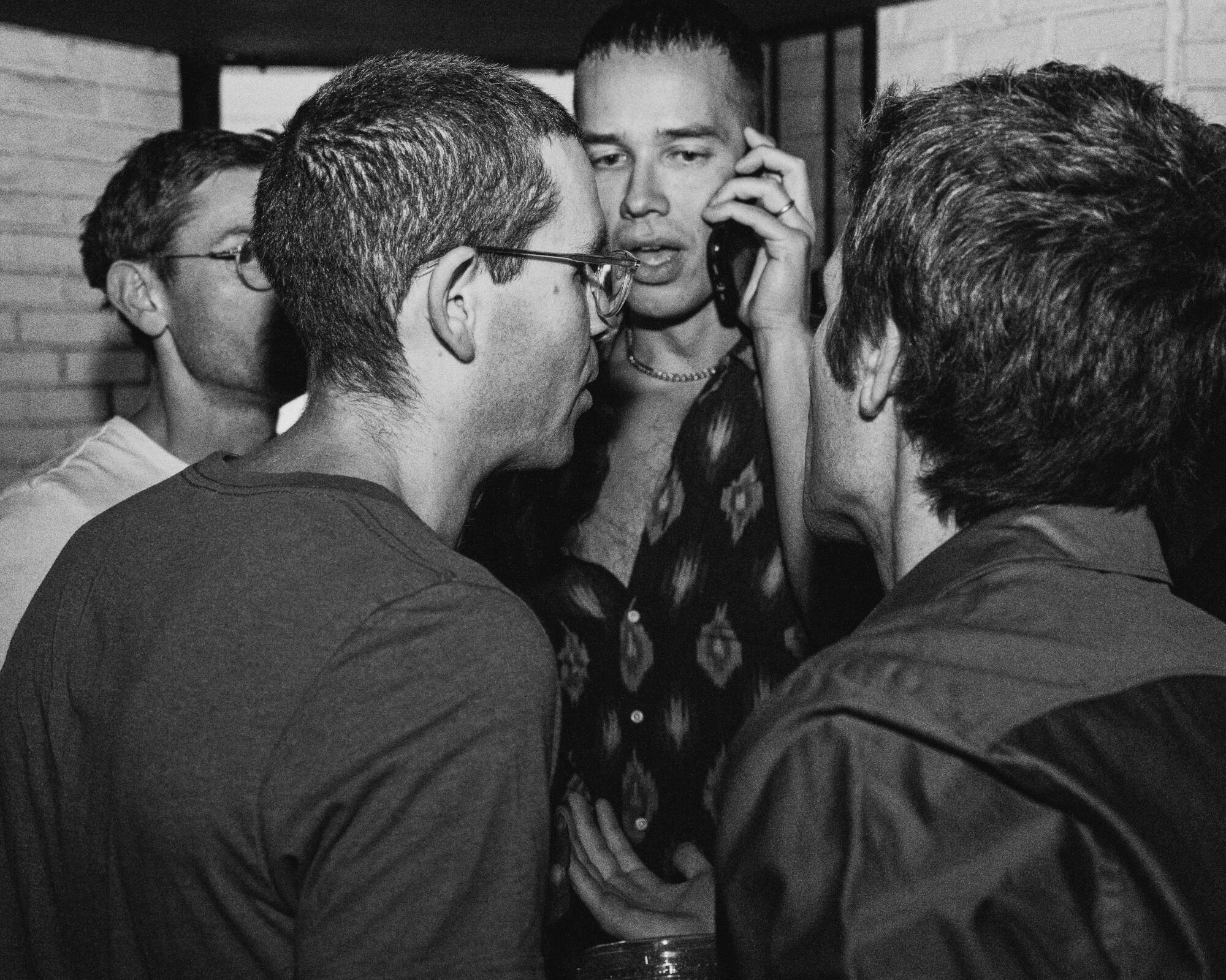 Guests huddle and talk.