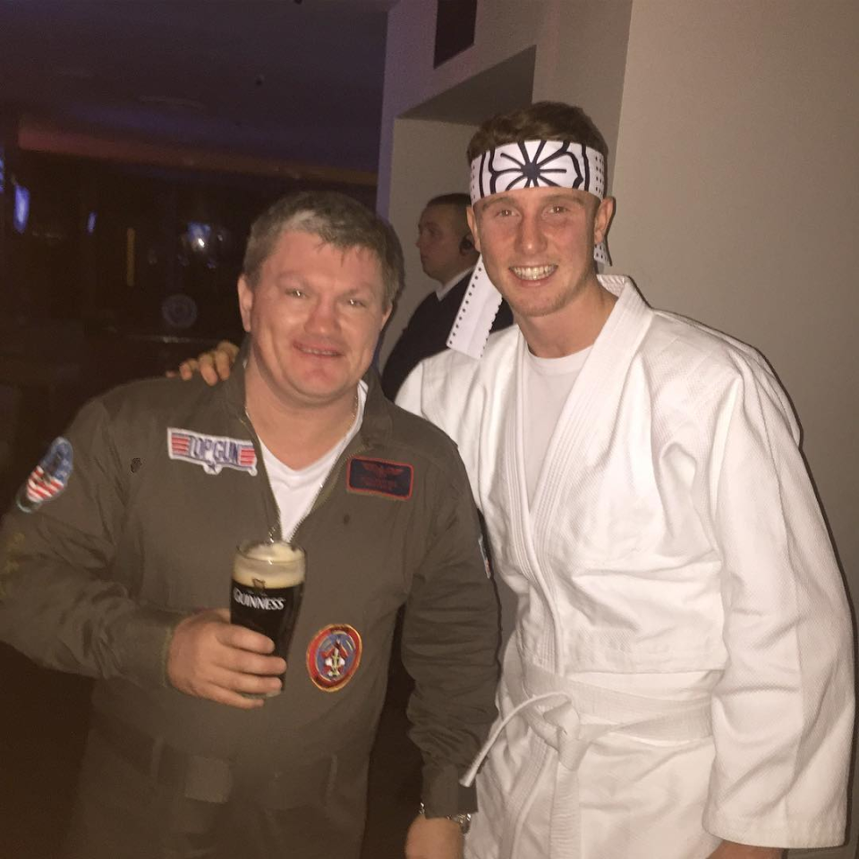 Ricky Hatton in a "Top Gun" costume holding a Guinness, with Brad Rea dressed as a karate kid.