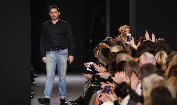 Designer Roland Mouret walks the runway after the Roland Mouret show at Paris Fashion Week 2016.
