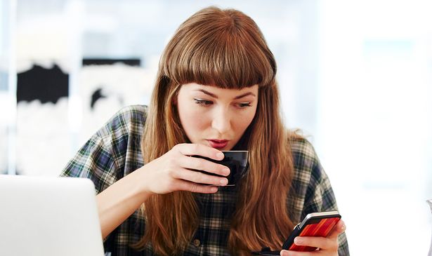 A woman checks her phone