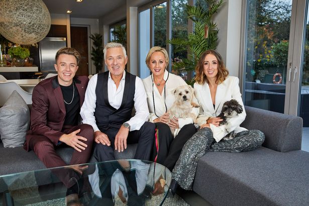 Roman, Martin, Shirlie and Harleymoon Kemp pose for a family photo in smart clothes, sitting on a sofa