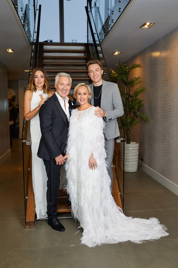 Harleymoon, Martin, Shirlie and Roman pose at the foot of a staircase