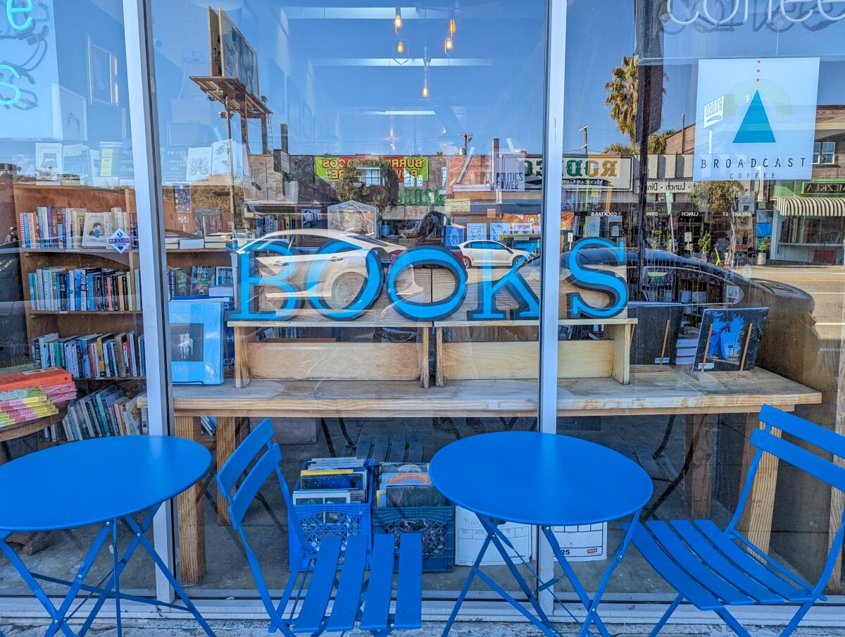 A look through a large glass window into a bookstore
