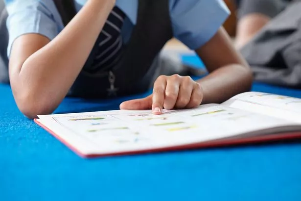 child reading book at school.