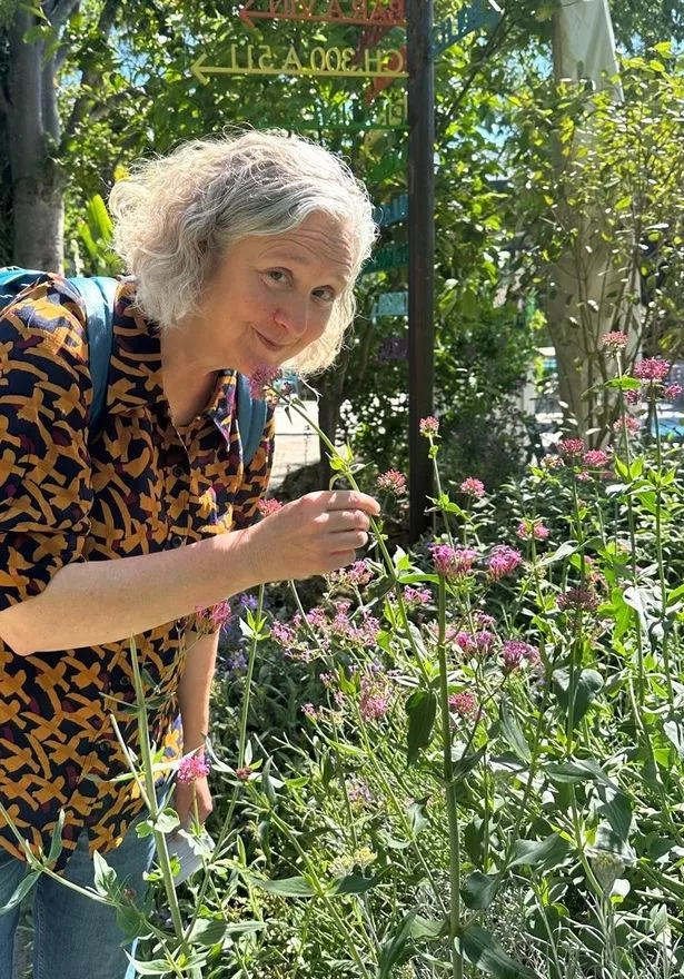 Ros smelling a flower