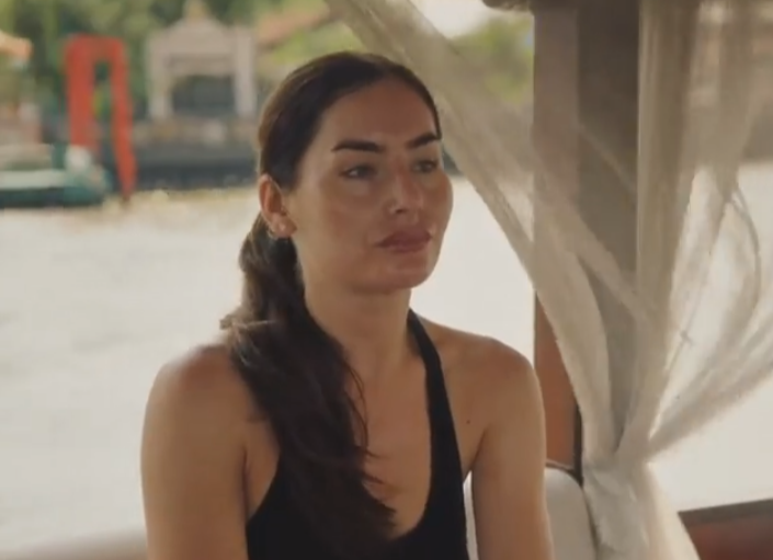 A woman in a black top on a boat.